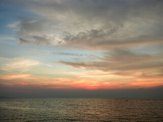 Thailand beautiful orange sunset sky and ocean. The far distance have the silhouette of the boats.