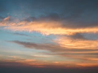 Fototapeta na wymiar Beautiful orange sunset sky with large white clouds.