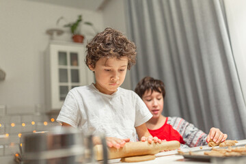happy family funny kids are preparing the dough, bake cookies in the kitchen