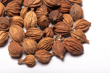 Heap of amomum villosum Lour dried fruit on a white background