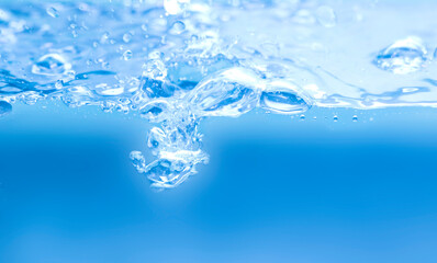 Naklejka na ściany i meble Water droplets and blue waves on a white background