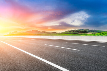 Asphalt road and mountain with tea plantation at sunset.Road and mountain background.