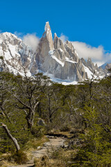 Patagonia's famous peak Cerro Torre with forest and hiking trail