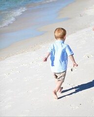 A Little Red-Haired Boy Running Down Laguna Beach in Panama City Beach, Florida