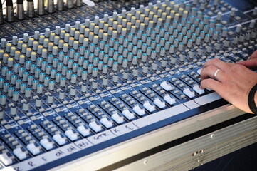 Sound mixing board displayed outdoors.