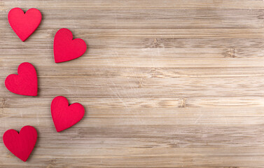 red wooden hearts on wooden background