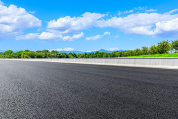 Asphalt road and green mountain under blue sky.Road and mountain background.