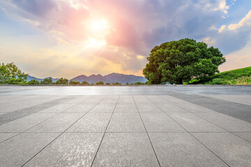 Empty square floor and green mountain background.