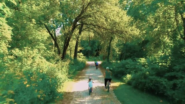 Riding Bicycles Through Wooded Trail