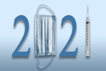Obraz premium Year 2021 with Medical Face mask and COVID Vaccine in a Syringe