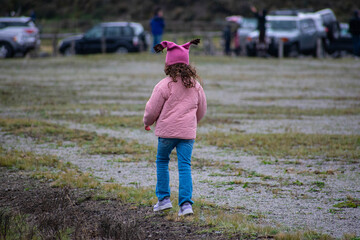 
girl with pink cap running through the moor