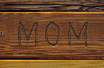MOM Carving Word Carved On Pier Wood 