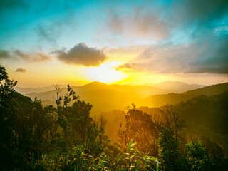 Majestic sunrise of the mountains layer in the morning with sun ray.
