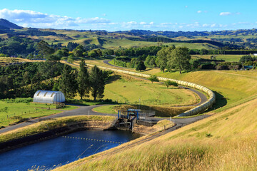 A water pipeline emerges from a reservoir and snakes across the countryside. Part of a...