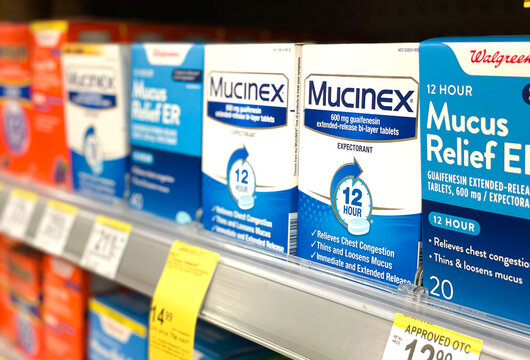 Packs of Mucinex are for sale at a Walgreens pharmacy..