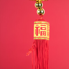 Tassel in front of red background