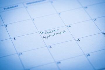 Doctor appointment reminder concept. Cropped close up view photo of calendar cell and hand written...