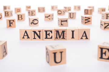 Anemia concept. Close up view photo of wooden cubes making showing word anemia on white table
