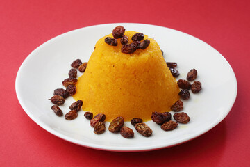 Plain or Saffron flavoured Semolina / Soji Halwa also known as Sweet Rava Sheera OR Shira - Indian festival sweet garnished with dry fruits. Served in a plate or Bowl