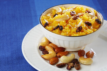 Plain or Saffron flavoured Semolina / Soji Halwa also known as Sweet Rava Sheera OR Shira - Indian festival sweet garnished with dry fruits. Served in a plate or Bowl