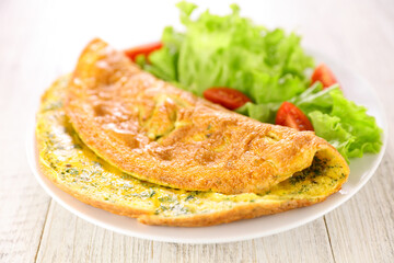 omelette with lettuce salad in plate