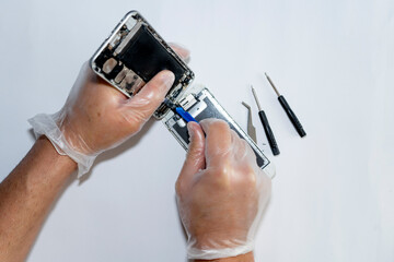 A person disassembling a smart phone for repair