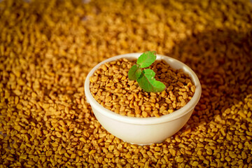 Fenugreek seeds in wooden bowl, spice, culinary ingredient,Fenugreek seeds in wooden spoon on beautiful background,methi closeup hd footage