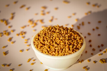 Fenugreek seeds in wooden bowl, spice, culinary ingredient,Fenugreek seeds in wooden spoon on beautiful background,methi closeup hd footage