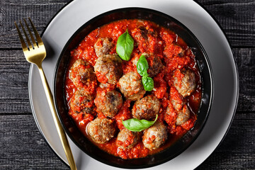 Italian meatballs on a black plate, top view
