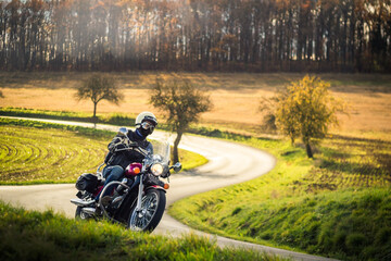 classic motorbike rider riding in autumn nature