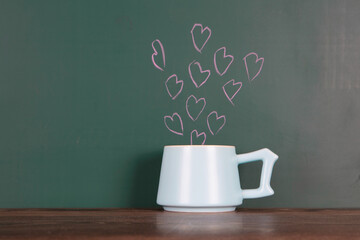 The cup in front of the blackboard and the abstract love emerging from it