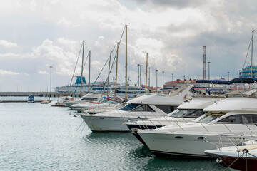 Speed boats at harbor. Power boats moored in marina. Sea coast pier.