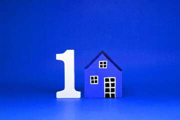 First House , Number 1 ( one ) with wooden home Isolated blue  Background and Copy Space - House...