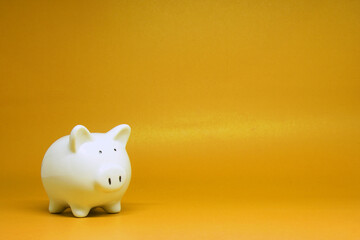 White Piggy bank isolated on yellow  background with copy space for text message - Fund , Investment , Saving money - yellow concept of Banking and finance concept 