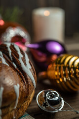 Holiday bun with poppy seeds, Christmas decorations and Santa bell.