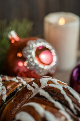 Holiday bun with poppy seeds, Christmas decorations and Santa bell.