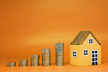 Growth Fund , Investment , Saving money concept : Home or House and money coin on yellow background...