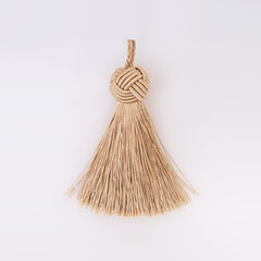 Golden silk tassel isolated on white background for creating graphic concepts