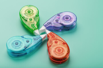 Multi-colored Stationery correction tapes on a blue background.