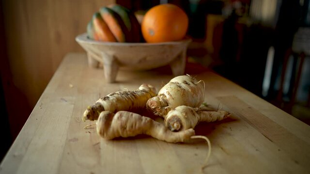 Push in of parsnips on a wooden table or cutting board
