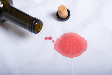 pouring red wine from a bottle on the table. 
