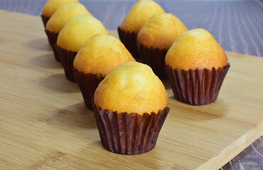 Close up in the center. Homemade mini muffins on slate table.