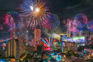 Fantastic Multicolor Firework exploding over the Bangkok Cityscape river side for Celebration, Business architecture and celebration and happy new year and merry Christmas concept, 2020 to 2021 years