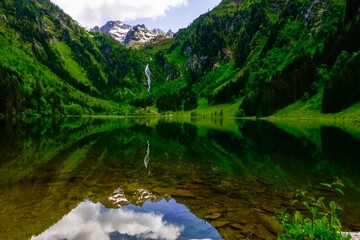 reflection from the mountains and sky in a mountain lake