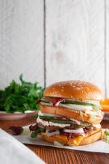Fast food Burger. Close-up of tasty burger on a dark wooden table and the background of a brick wall. Different type of sandwiches
