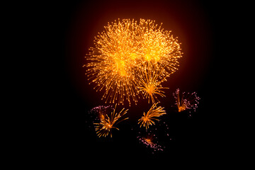 Big beautiful golden fireworks in the night sky on a festive day
