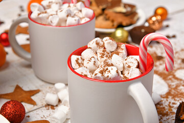 sweet food top view background for merry christmas or new year holiday decoration - chocolate candies, tangerines, cookies, marshmallow and cocoa latte on white wood