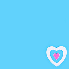 Minimal composition with white and pink hearts on pastel blue background. Valentines day concept.