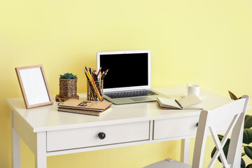 Modern workplace with laptop and decor