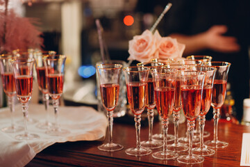 Glasses of rose sparkle wine on bar desk